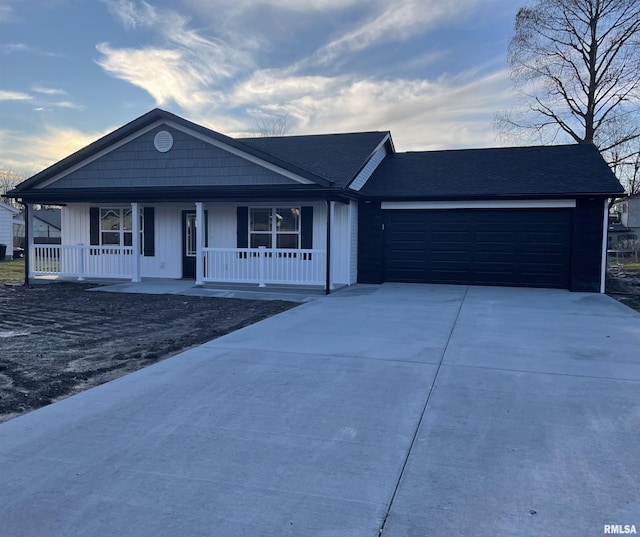 view of front of house featuring a porch and a garage