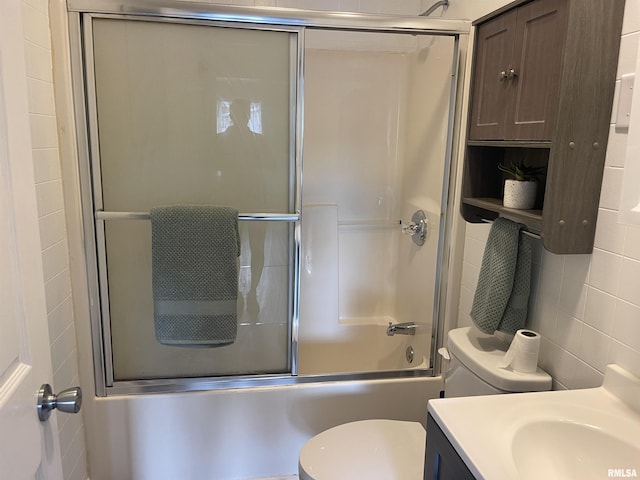 full bathroom with shower / bath combination with glass door, tasteful backsplash, vanity, and toilet