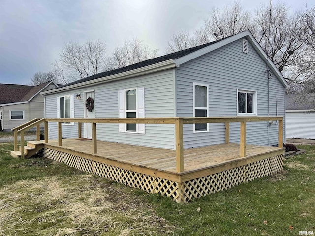 rear view of property featuring a deck