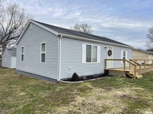 rear view of property featuring a lawn