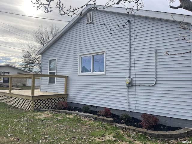 view of home's exterior featuring a wooden deck