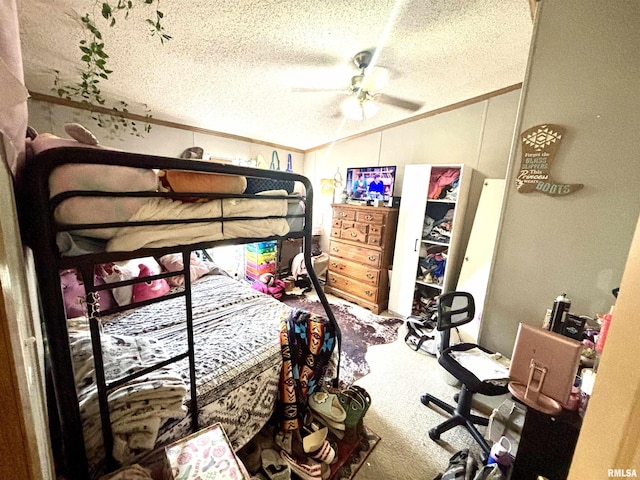 carpeted bedroom with ceiling fan, a textured ceiling, ornamental molding, and vaulted ceiling