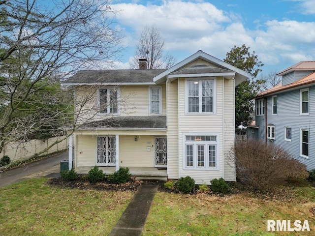 front of property featuring a front yard and a porch