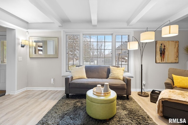 living room with beamed ceiling, light hardwood / wood-style floors, and crown molding