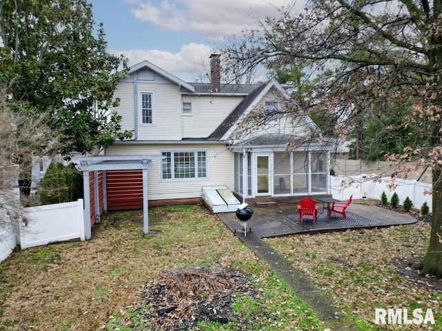 back of property featuring a sunroom and a patio