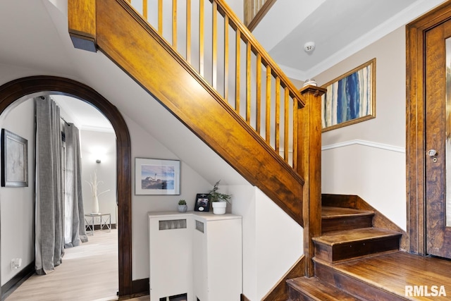 staircase featuring crown molding