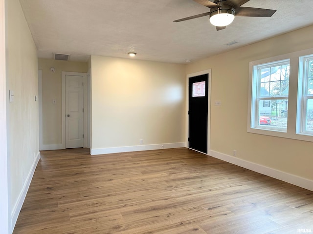 empty room featuring light wood-type flooring and ceiling fan