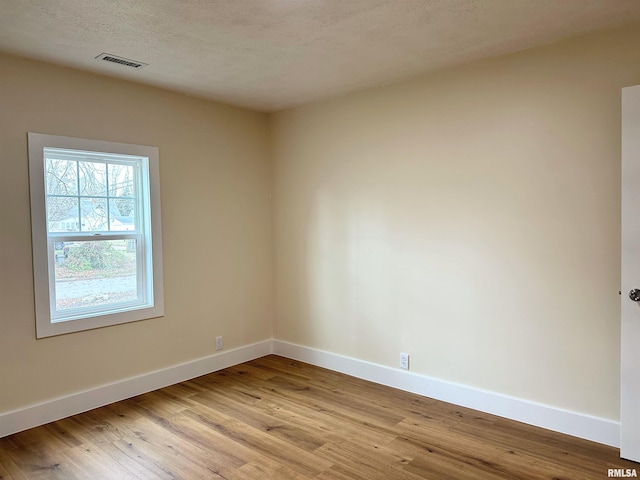 spare room featuring light wood-type flooring