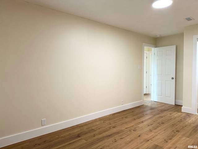 empty room with hardwood / wood-style flooring