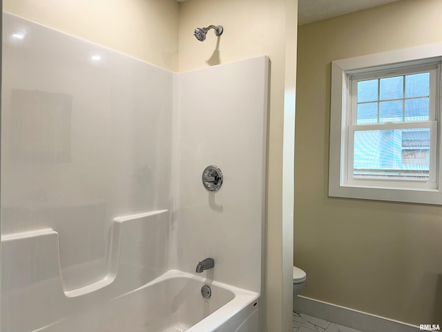 bathroom featuring shower / bath combination and toilet