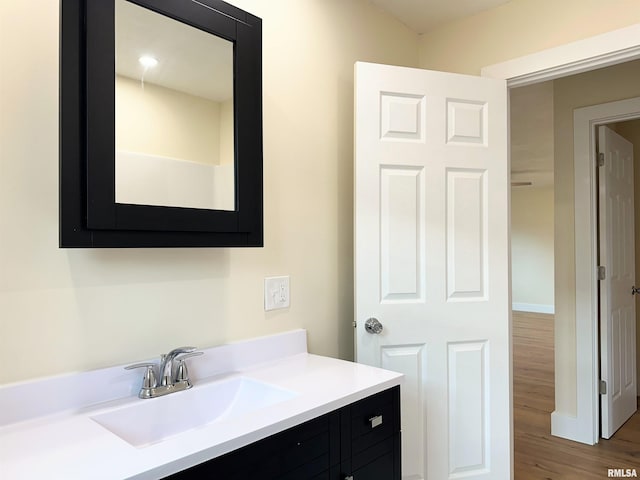 bathroom with hardwood / wood-style flooring and vanity