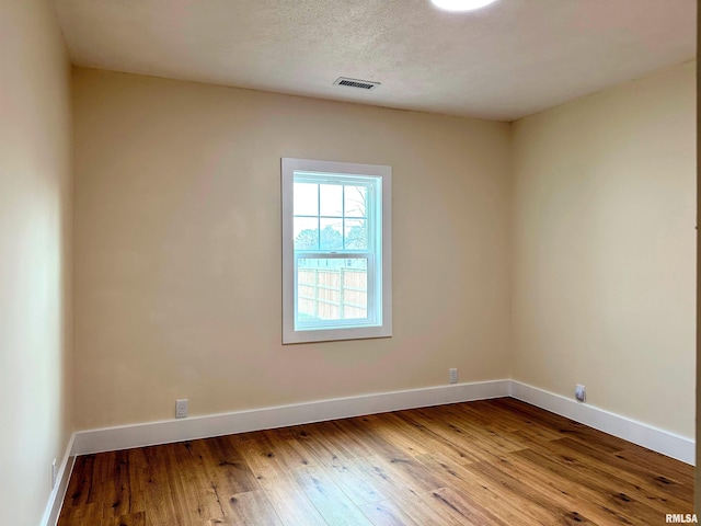 empty room featuring hardwood / wood-style flooring