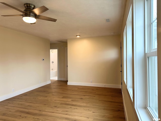 empty room with hardwood / wood-style flooring and ceiling fan