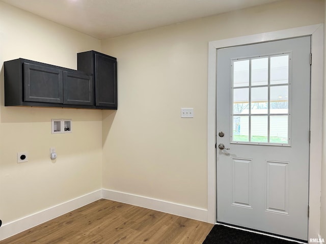 laundry room with cabinets, hookup for a washing machine, light wood-type flooring, and electric dryer hookup