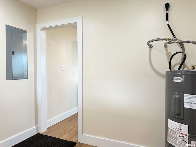 utility room with electric panel and electric water heater