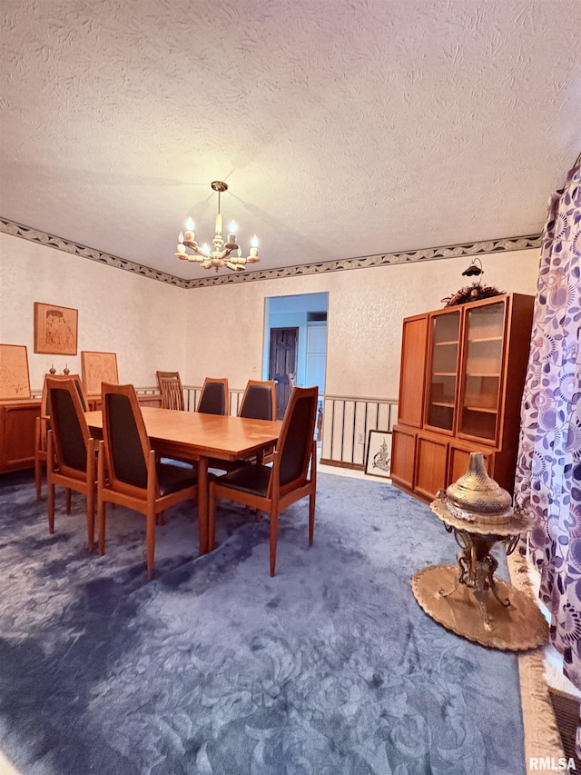 carpeted dining space featuring a chandelier and a textured ceiling