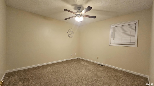 spare room with ceiling fan, carpet, and a textured ceiling