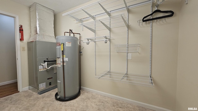 utility room with electric water heater