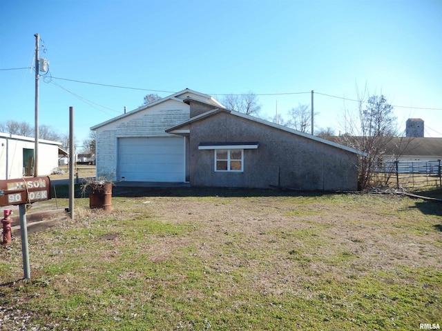 90 Oak St, Jonesboro, IL 62952 - view of home's exterior featuring a garage and a yard