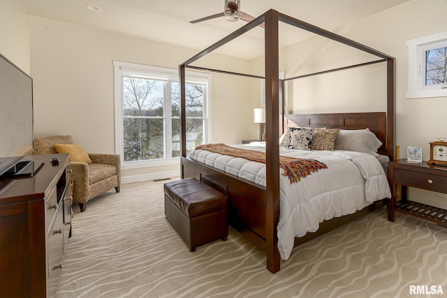 bedroom with ceiling fan and light colored carpet