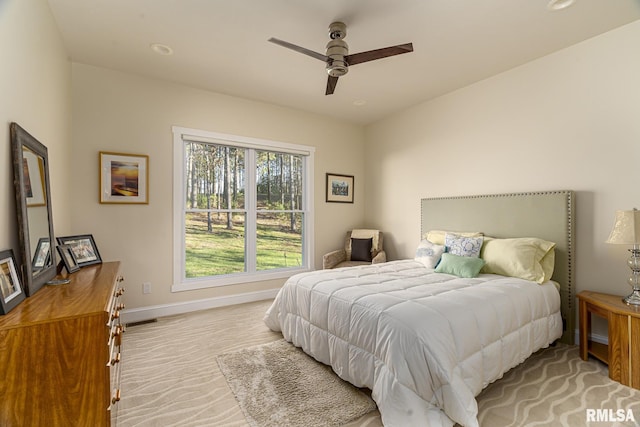 bedroom featuring ceiling fan and light carpet