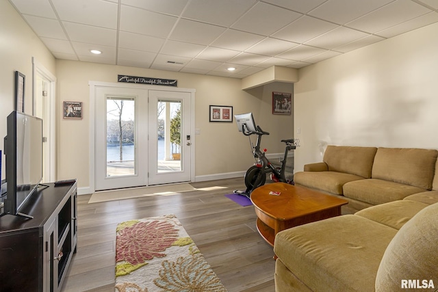 living room featuring a paneled ceiling and hardwood / wood-style floors