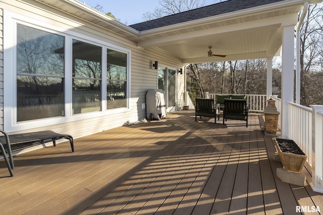 wooden terrace with a porch and ceiling fan