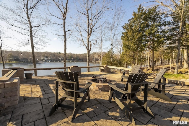 view of patio / terrace featuring a water view and an outdoor fire pit