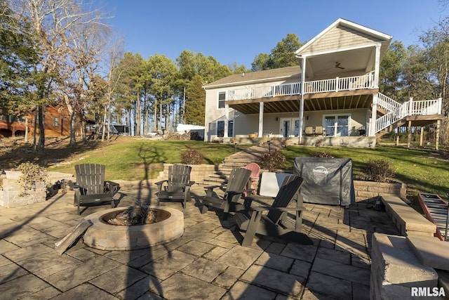 back of property featuring a patio, a balcony, an outdoor fire pit, and ceiling fan