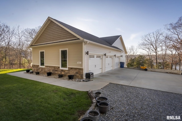 view of home's exterior featuring a lawn and a garage