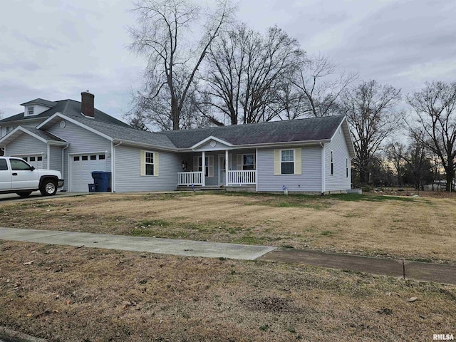 view of front facade with covered porch, a garage, and a front lawn