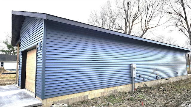 view of side of home with a garage and an outdoor structure