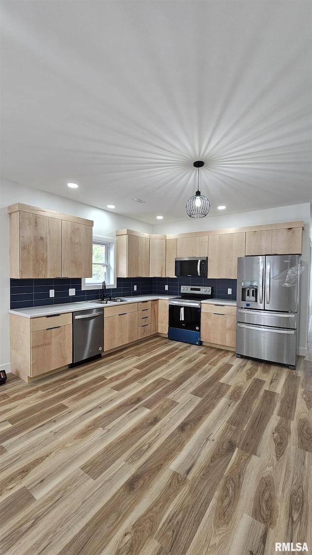 809 N 27th St, Herrin, IL 62948 - kitchen featuring appliances with stainless steel finishes, light wood-style floors, and light brown cabinets