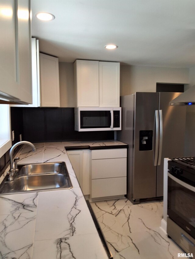 309 W 11th St, Metropolis, IL 62960 - kitchen featuring marble finish floor, white cabinetry, a sink, and stainless steel appliances