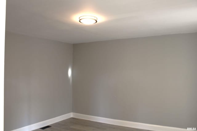 empty room featuring dark wood-type flooring