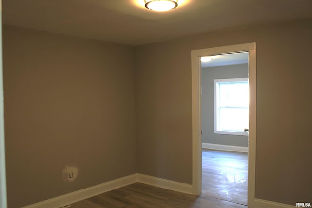 unfurnished room with wood-type flooring