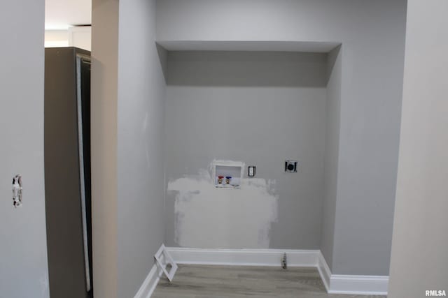 laundry area featuring hookup for an electric dryer, hookup for a washing machine, and light wood-type flooring