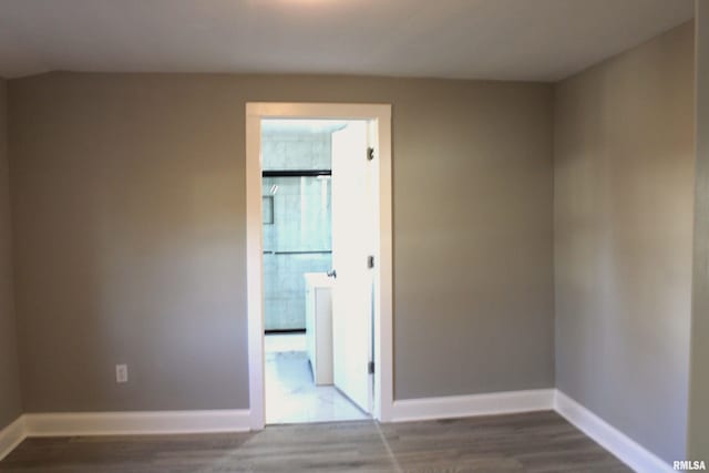 unfurnished room featuring plenty of natural light and wood-type flooring