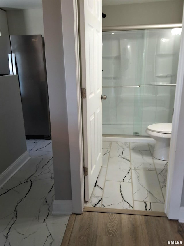 309 W 11th St, Metropolis, IL 62960 - full bath featuring marble finish floor, baseboards, a stall shower, and toilet