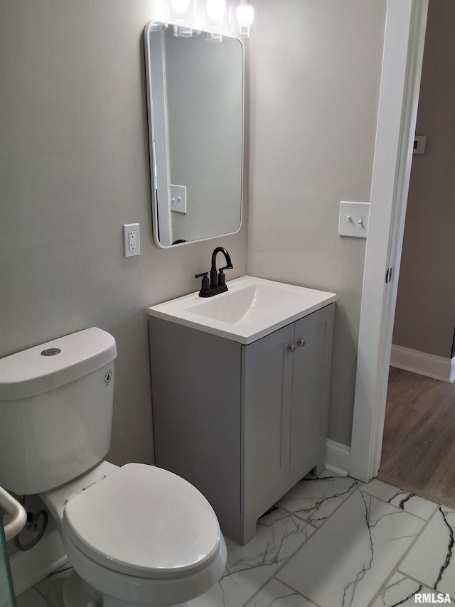 309 W 11th St, Metropolis, IL 62960 - bathroom featuring marble finish floor, vanity, toilet, and baseboards