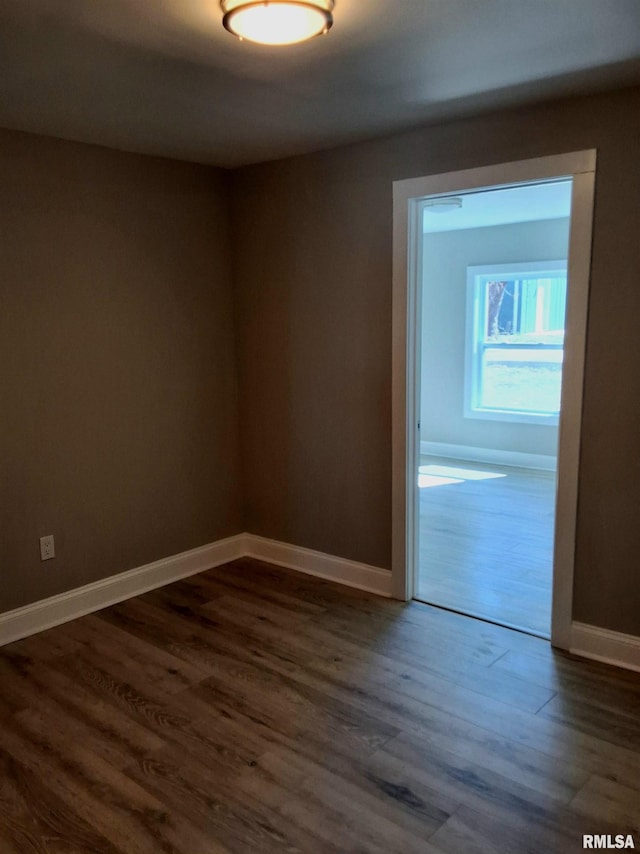309 W 11th St, Metropolis, IL 62960 - unfurnished room featuring baseboards and dark wood-style floors