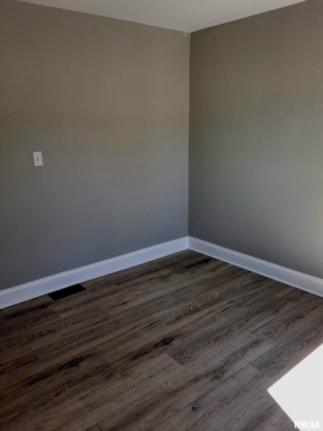 309 W 11th St, Metropolis, IL 62960 - empty room featuring baseboards and dark wood-style flooring