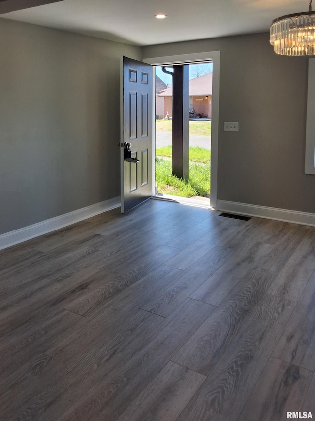 309 W 11th St, Metropolis, IL 62960 - entryway featuring baseboards, dark wood-style flooring, visible vents, and an inviting chandelier