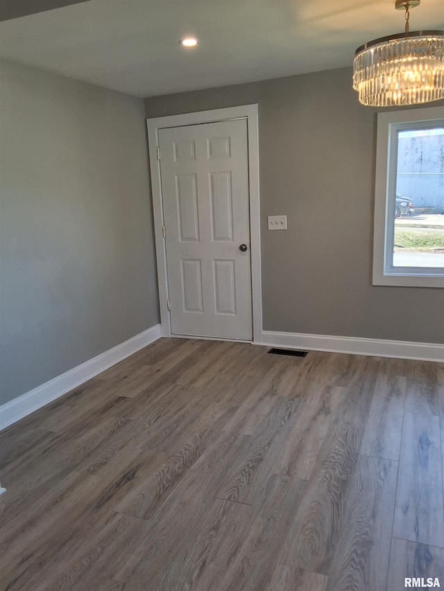 309 W 11th St, Metropolis, IL 62960 - empty room with recessed lighting, baseboards, a chandelier, visible vents, and wood finished floors