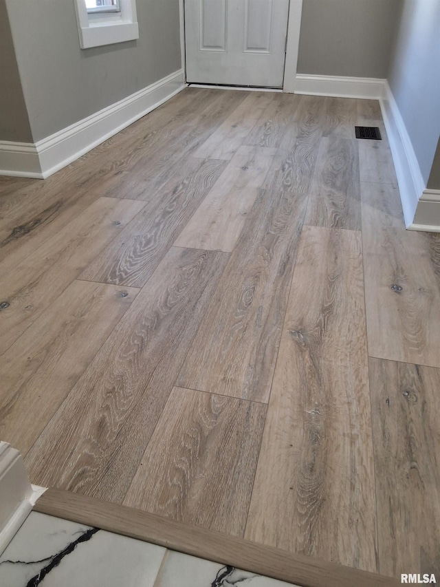 309 W 11th St, Metropolis, IL 62960 - room details with baseboards, visible vents, and wood finished floors