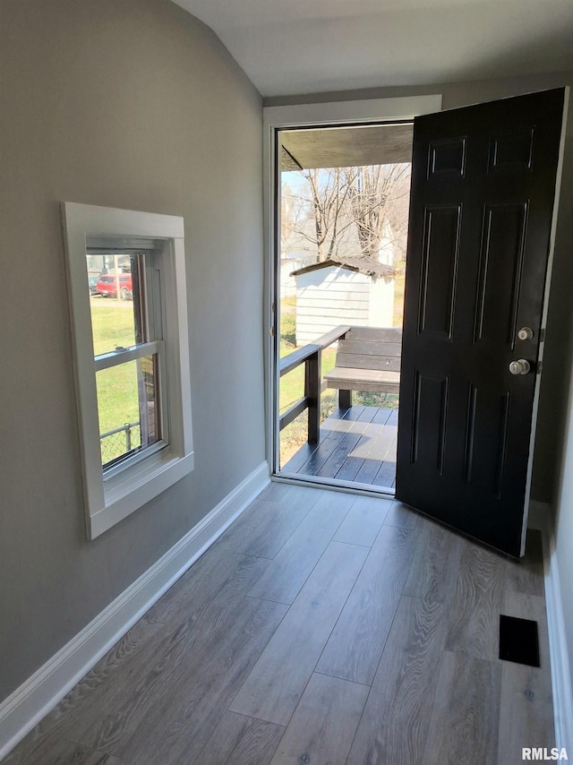 309 W 11th St, Metropolis, IL 62960 - entrance foyer with baseboards, lofted ceiling, and wood finished floors