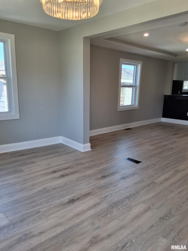 309 W 11th St, Metropolis, IL 62960 - interior space featuring visible vents, a chandelier, baseboards, wood finished floors, and a tray ceiling