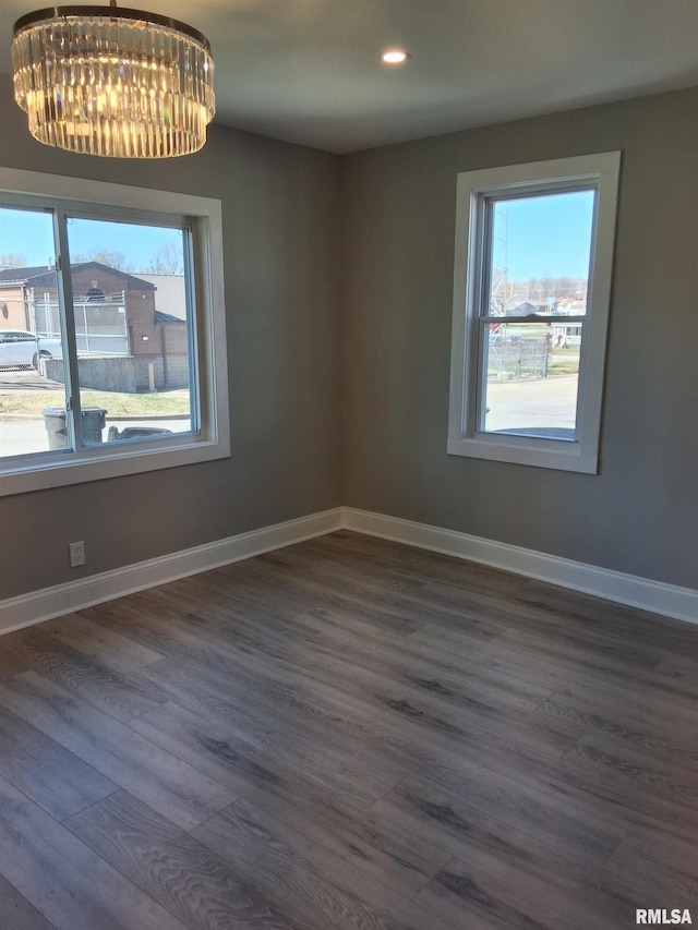 309 W 11th St, Metropolis, IL 62960 - empty room with dark wood finished floors, baseboards, recessed lighting, and a chandelier