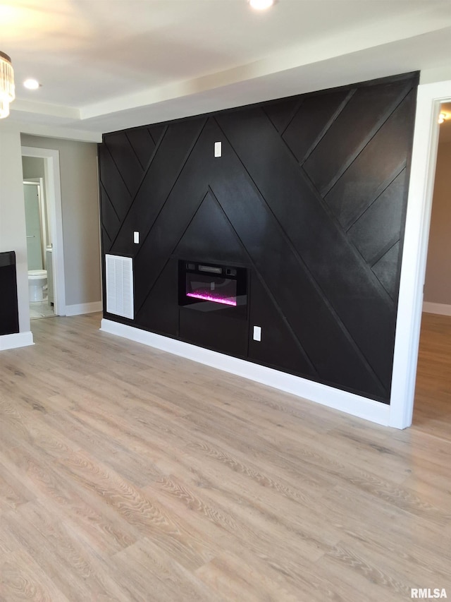 309 W 11th St, Metropolis, IL 62960 - interior space featuring baseboards, visible vents, wood finished floors, and a glass covered fireplace