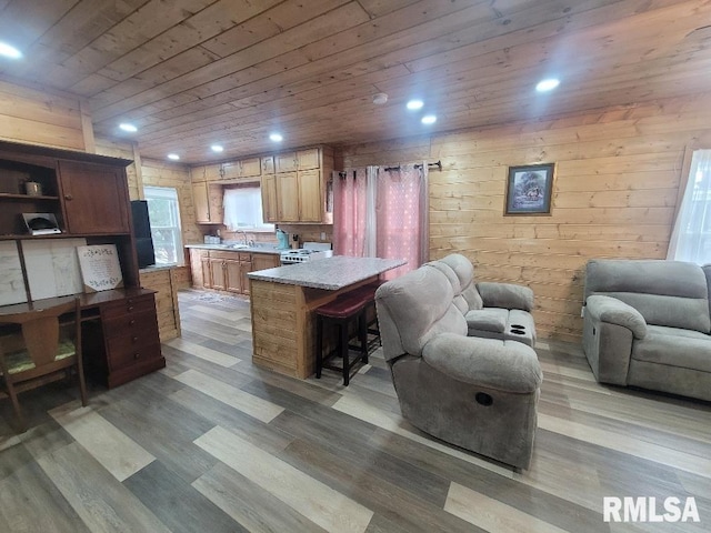 interior space featuring light wood-type flooring, wooden ceiling, and wooden walls